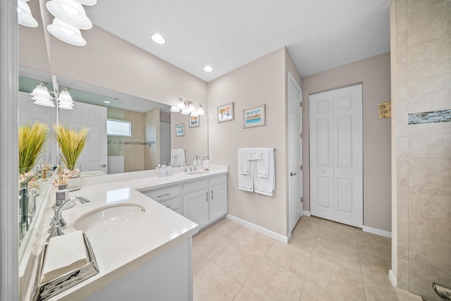 11187 SW Lake Park Dr, Port Saint Lucie, FL 34987 - full bathroom with double vanity, baseboards, a chandelier, tile patterned flooring, and recessed lighting