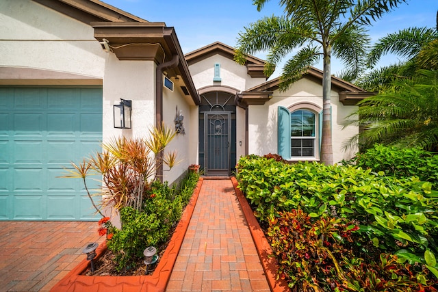 11187 SW Lake Park Dr, Port Saint Lucie, FL 34987 - entrance to property with stucco siding and a garage