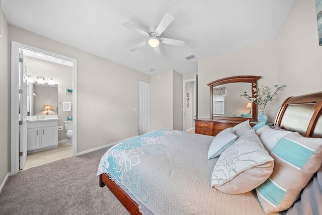 11187 SW Lake Park Dr, Port Saint Lucie, FL 34987 - bedroom with light colored carpet, baseboards, ensuite bathroom, and ceiling fan