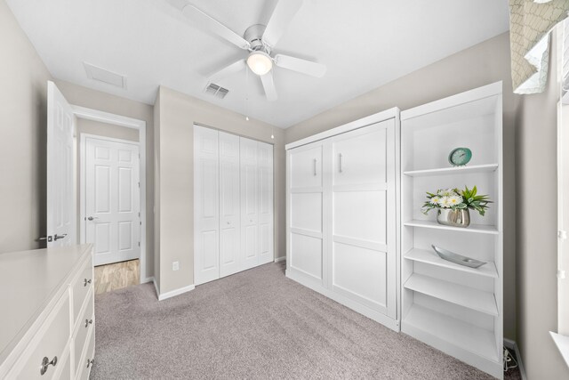 11187 SW Lake Park Dr, Port Saint Lucie, FL 34987 - unfurnished bedroom with light colored carpet, a closet, a ceiling fan, baseboards, and attic access