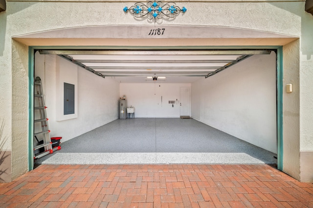 11187 SW Lake Park Dr, Port Saint Lucie, FL 34987 - garage featuring electric panel and electric water heater