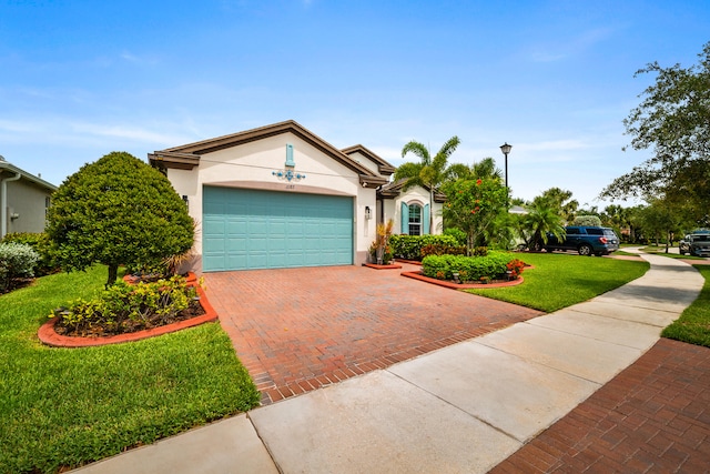 11187 SW Lake Park Dr, Port Saint Lucie, FL 34987 - single story home featuring stucco siding, decorative driveway, a front lawn, and a garage