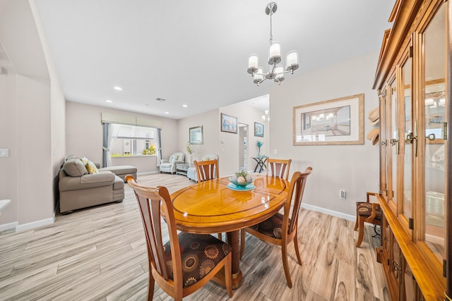 11187 SW Lake Park Dr, Port Saint Lucie, FL 34987 - dining area with a chandelier, light wood finished floors, baseboards, and recessed lighting