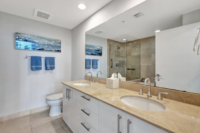550 Okeechobee Blvd Unit 504, West Palm Beach, FL 33401 - full bathroom featuring tiled shower, toilet, double vanity, tile patterned flooring, and baseboards