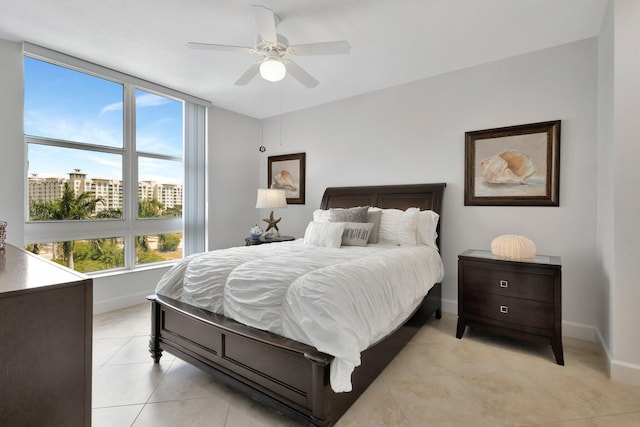 550 Okeechobee Blvd Unit 504, West Palm Beach, FL 33401 - bedroom with baseboards, light tile patterned floors, and ceiling fan