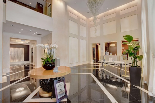 550 Okeechobee Blvd Unit 504, West Palm Beach, FL 33401 - corridor with granite floors, a high ceiling, and baseboards
