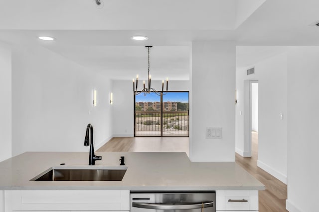 7076 Huntington Ln Unit 206, Delray Beach, FL 33446 - kitchen featuring stainless steel dishwasher, white cabinetry, recessed lighting, and light wood-style flooring