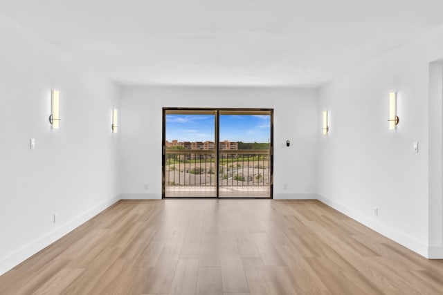 7076 Huntington Ln Unit 206, Delray Beach, FL 33446 - spare room featuring light wood-style floors and baseboards