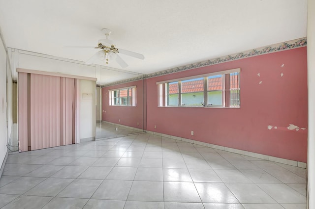 5800 Fernley Dr W Unit 51, Greenacres, FL 33415 - spare room featuring a ceiling fan, baseboards, and light tile patterned floors