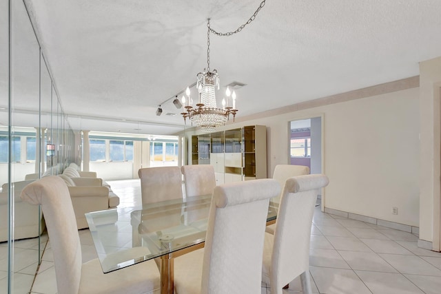 5800 Fernley Dr W Unit 51, Greenacres, FL 33415 - dining area with a chandelier, light tile patterned floors, a textured ceiling, and baseboards