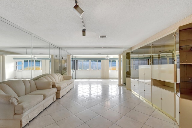 5800 Fernley Dr W Unit 51, Greenacres, FL 33415 - living area with a textured ceiling, light tile patterned flooring, and rail lighting