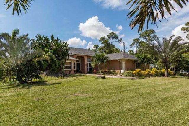 5775 Reynolds Rd, Lake Worth, FL 33449 - view of front facade featuring a front yard and stucco siding