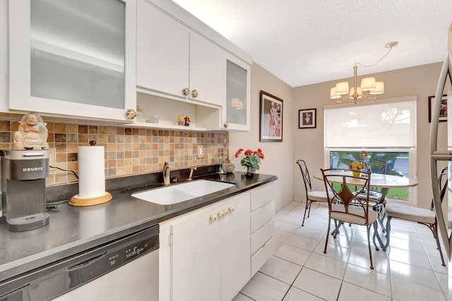 13691 Via Aurora Unit C, Delray Beach, FL 33484 - kitchen featuring dishwasher, a sink, backsplash, dark countertops, and a textured ceiling