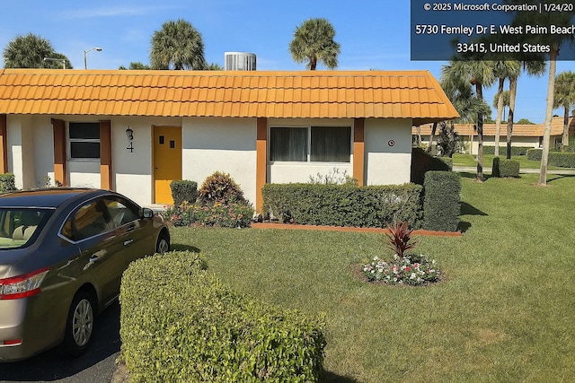 5730 Fernley Dr E Unit 4, West Palm Beach, FL 33415 - view of front of property featuring a tile roof, stucco siding, and a front yard