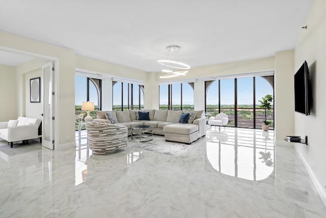 7578 Regency Lake Dr Unit 802, Boca Raton, FL 33433 - living room featuring marble tiled floors, healthy amount of natural light, and a chandelier