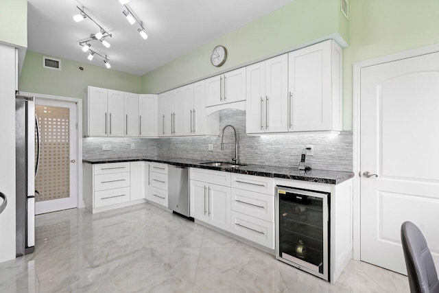 7578 Regency Lake Dr Unit 802, Boca Raton, FL 33433 - kitchen featuring wine cooler, appliances with stainless steel finishes, light marble finish flooring, and decorative backsplash