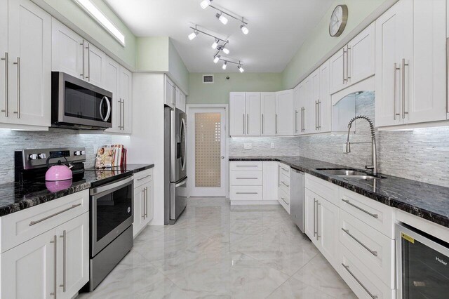 7578 Regency Lake Dr Unit 802, Boca Raton, FL 33433 - kitchen with appliances with stainless steel finishes, beverage cooler, backsplash, and light marble finish floors
