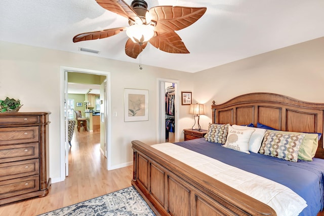 200 N High Point Blvd Unit C, Boynton Beach, FL 33435 - bedroom featuring light wood finished floors, baseboards, a spacious closet, a closet, and a ceiling fan