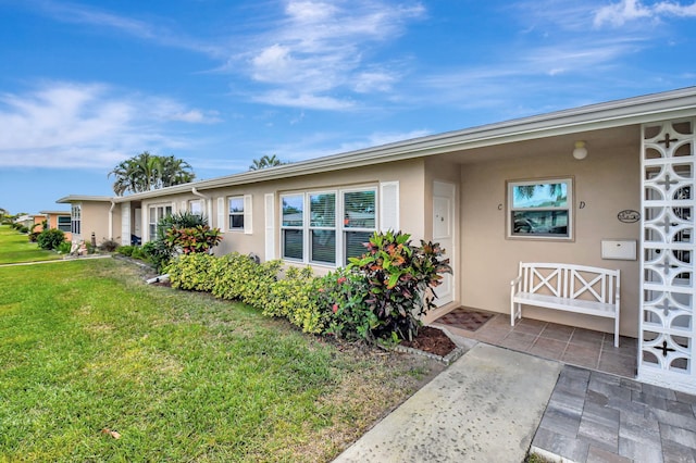 200 N High Point Blvd Unit C, Boynton Beach, FL 33435 - view of front of house with stucco siding and a front lawn
