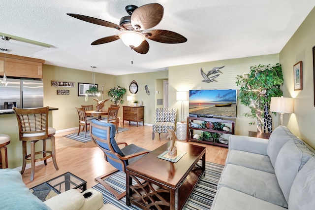 200 N High Point Blvd Unit C, Boynton Beach, FL 33435 - living area with a ceiling fan, light wood-type flooring, a textured ceiling, and baseboards
