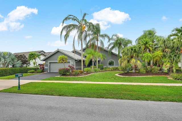 10795 Boca Woods Ln, Boca Raton, FL 33428 - view of front of home featuring driveway, an attached garage, stucco siding, and a front lawn