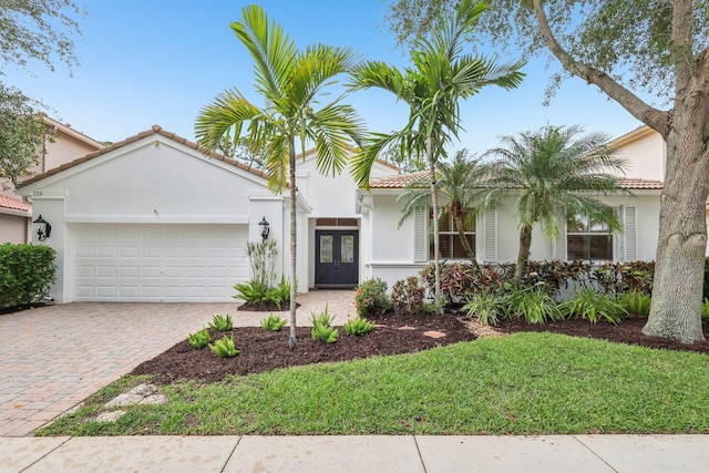 139 Sedona Way, Palm Beach Gardens, FL 33418 - view of front facade featuring a tiled roof, an attached garage, stucco siding, and decorative driveway