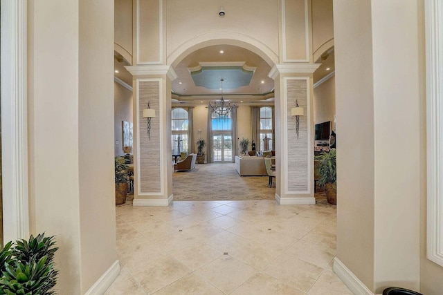 139 Sedona Way, Palm Beach Gardens, FL 33418 - tiled entryway with ornate columns, crown molding, a chandelier, arched walkways, and recessed lighting