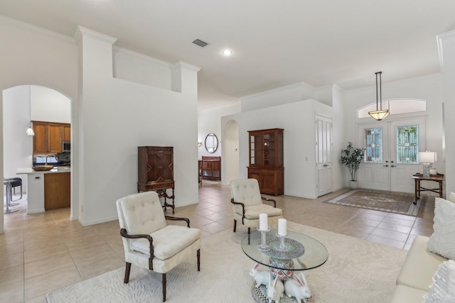 139 Sedona Way, Palm Beach Gardens, FL 33418 - living room with arched walkways, light tile patterned floors, ornamental molding, and a high ceiling
