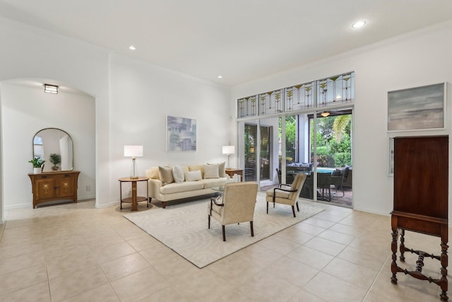 139 Sedona Way, Palm Beach Gardens, FL 33418 - living room with light tile patterned floors, arched walkways, recessed lighting, a towering ceiling, and ornamental molding