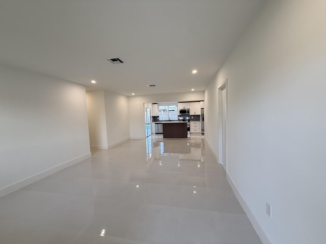 345 Pinehurst Rd, Palm Springs, FL 33461 - hallway with baseboards, recessed lighting, and light tile patterned floors