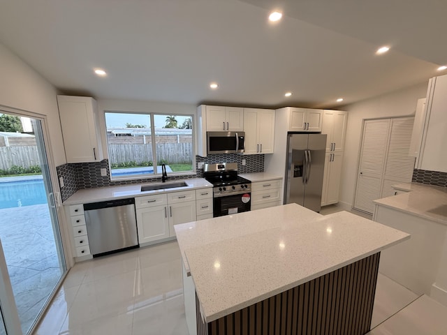 345 Pinehurst Rd, Palm Springs, FL 33461 - kitchen with appliances with stainless steel finishes, backsplash, a sink, light stone counters, and recessed lighting
