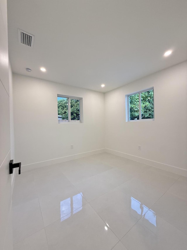 345 Pinehurst Rd, Palm Springs, FL 33461 - empty room featuring healthy amount of natural light, baseboards, recessed lighting, and light tile patterned floors