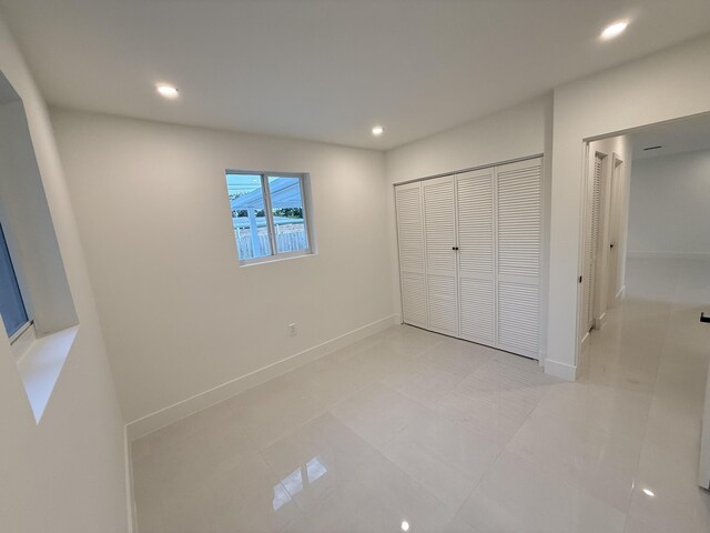 345 Pinehurst Rd, Palm Springs, FL 33461 - unfurnished bedroom with recessed lighting, baseboards, a closet, and light tile patterned floors