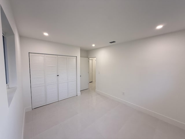 345 Pinehurst Rd, Palm Springs, FL 33461 - unfurnished bedroom featuring recessed lighting, baseboards, a closet, and light tile patterned floors