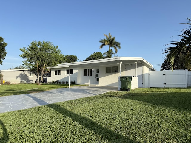 345 Pinehurst Rd, Palm Springs, FL 33461 - rear view of house featuring concrete driveway, a gate, a carport, and stucco siding
