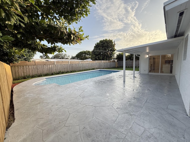 345 Pinehurst Rd, Palm Springs, FL 33461 - view of swimming pool featuring a patio and a fenced backyard