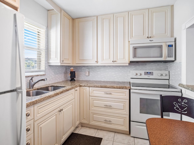 715 Lori Dr Unit 213, Palm Springs, FL 33461 - kitchen with white appliances, a sink, cream cabinets, light tile patterned floors, and tasteful backsplash