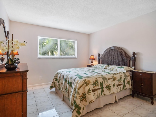715 Lori Dr Unit 213, Palm Springs, FL 33461 - bedroom featuring light tile patterned flooring, a textured ceiling, and baseboards