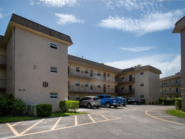 715 Lori Dr Unit 213, Palm Springs, FL 33461 - view of apartment building / complex featuring uncovered parking