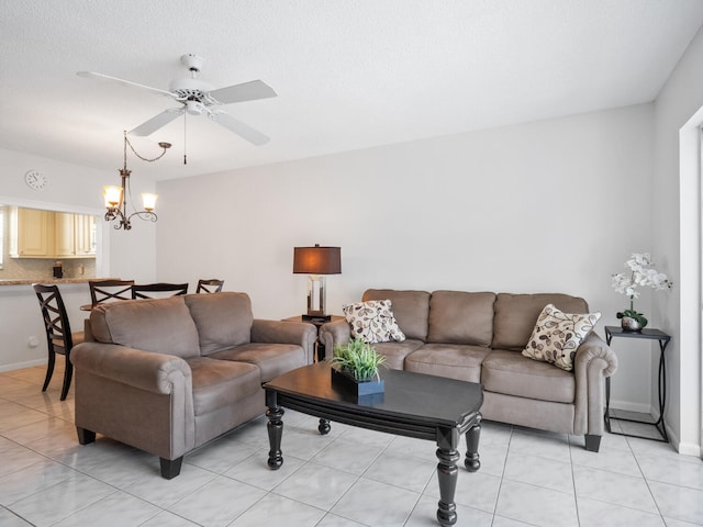 715 Lori Dr Unit 213, Palm Springs, FL 33461 - living area featuring a ceiling fan, a chandelier, light tile patterned floors, and baseboards