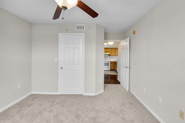 15185 Michelangelo Blvd Unit 204, Delray Beach, FL 33446 - unfurnished bedroom featuring light carpet, baseboards, and a ceiling fan