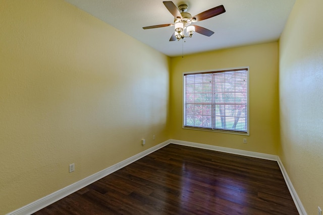 473 SW Dagget Ave, Port Saint Lucie, FL 34953 - spare room with dark wood-style flooring, a ceiling fan, and baseboards