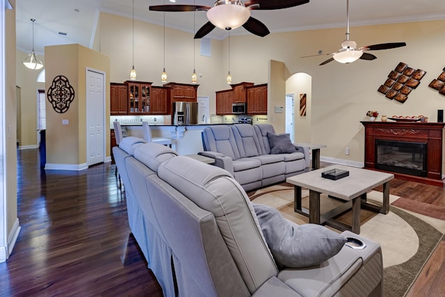 473 SW Dagget Ave, Port Saint Lucie, FL 34953 - living area with high vaulted ceiling, ceiling fan, dark wood-style floors, baseboards, and ornamental molding