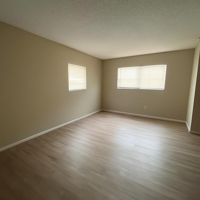 500 SW 2nd Ave Unit 120, Boca Raton, FL 33432 - unfurnished room featuring wood finished floors, a textured ceiling, and baseboards