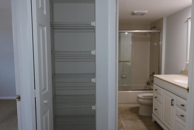 3507 Village Blvd Unit 401, West Palm Beach, FL 33409 - bathroom featuring toilet, vanity, and combined bath / shower with glass door