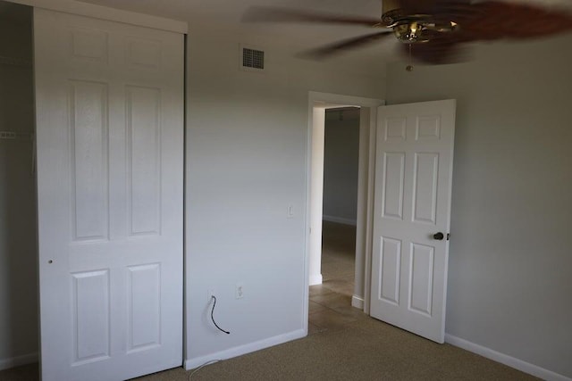 3507 Village Blvd Unit 401, West Palm Beach, FL 33409 - unfurnished bedroom with light carpet, baseboards, and ceiling fan