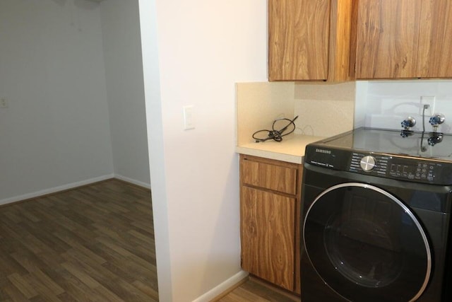 3507 Village Blvd Unit 401, West Palm Beach, FL 33409 - laundry room with washer / clothes dryer, cabinet space, wood finished floors, and baseboards