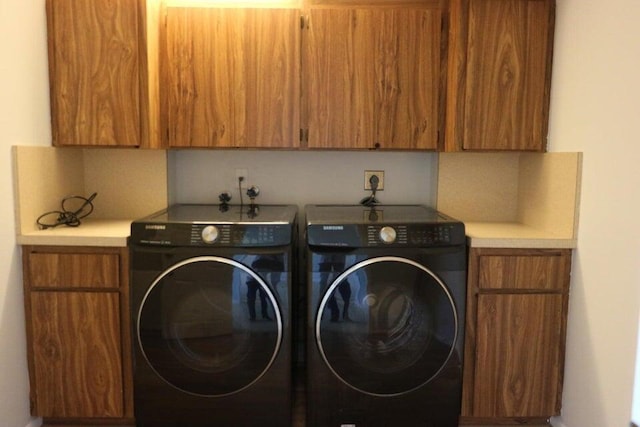 3507 Village Blvd Unit 401, West Palm Beach, FL 33409 - laundry room with cabinet space and separate washer and dryer