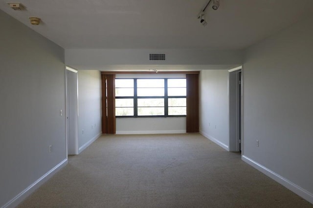 3507 Village Blvd Unit 401, West Palm Beach, FL 33409 - empty room featuring carpet, rail lighting, and baseboards