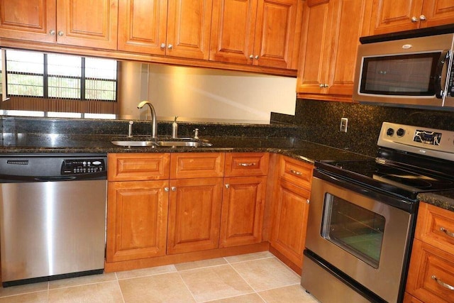 3507 Village Blvd Unit 401, West Palm Beach, FL 33409 - kitchen with stainless steel appliances, a sink, and brown cabinets